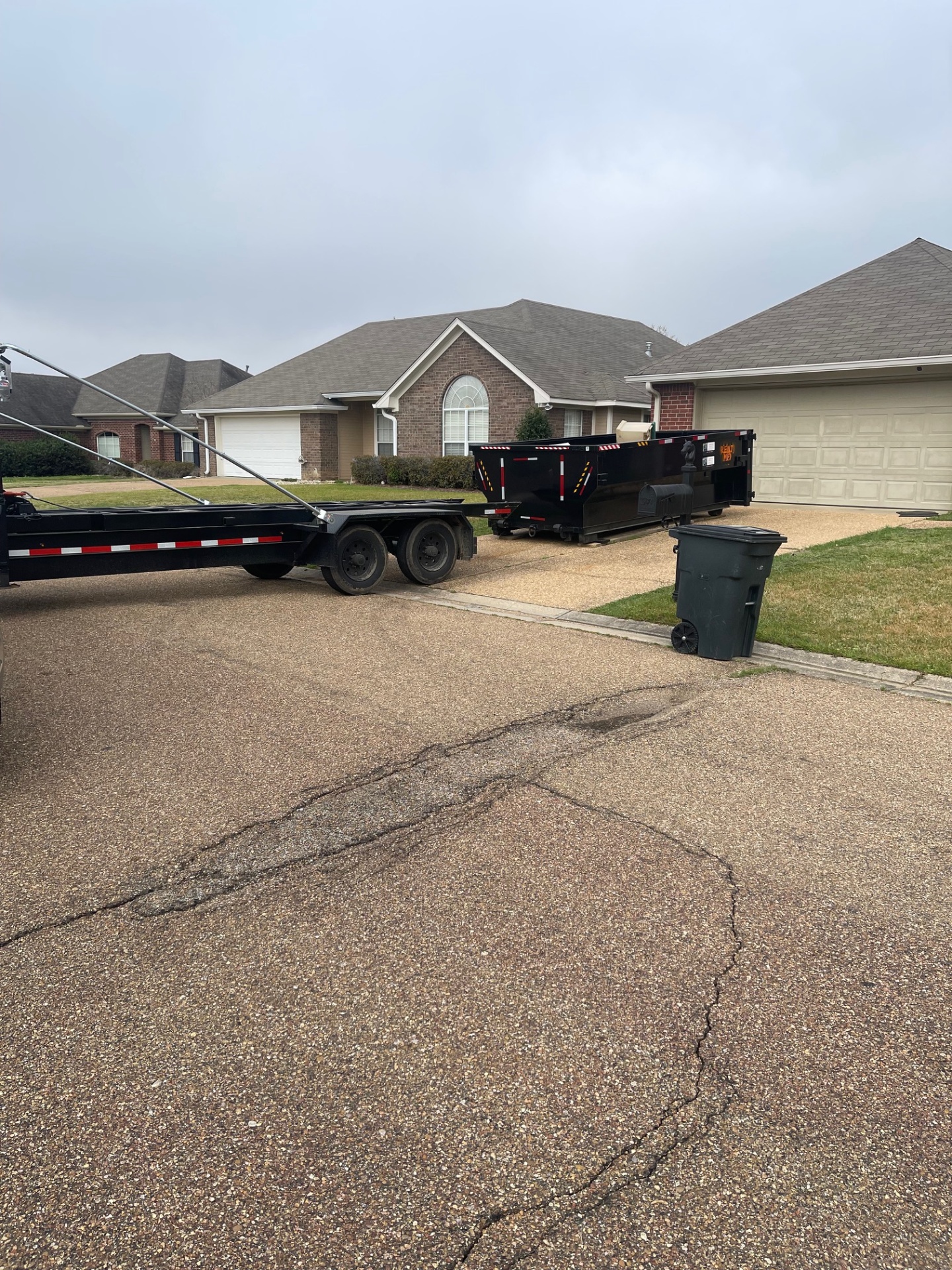Dumpster set in a residential driveway