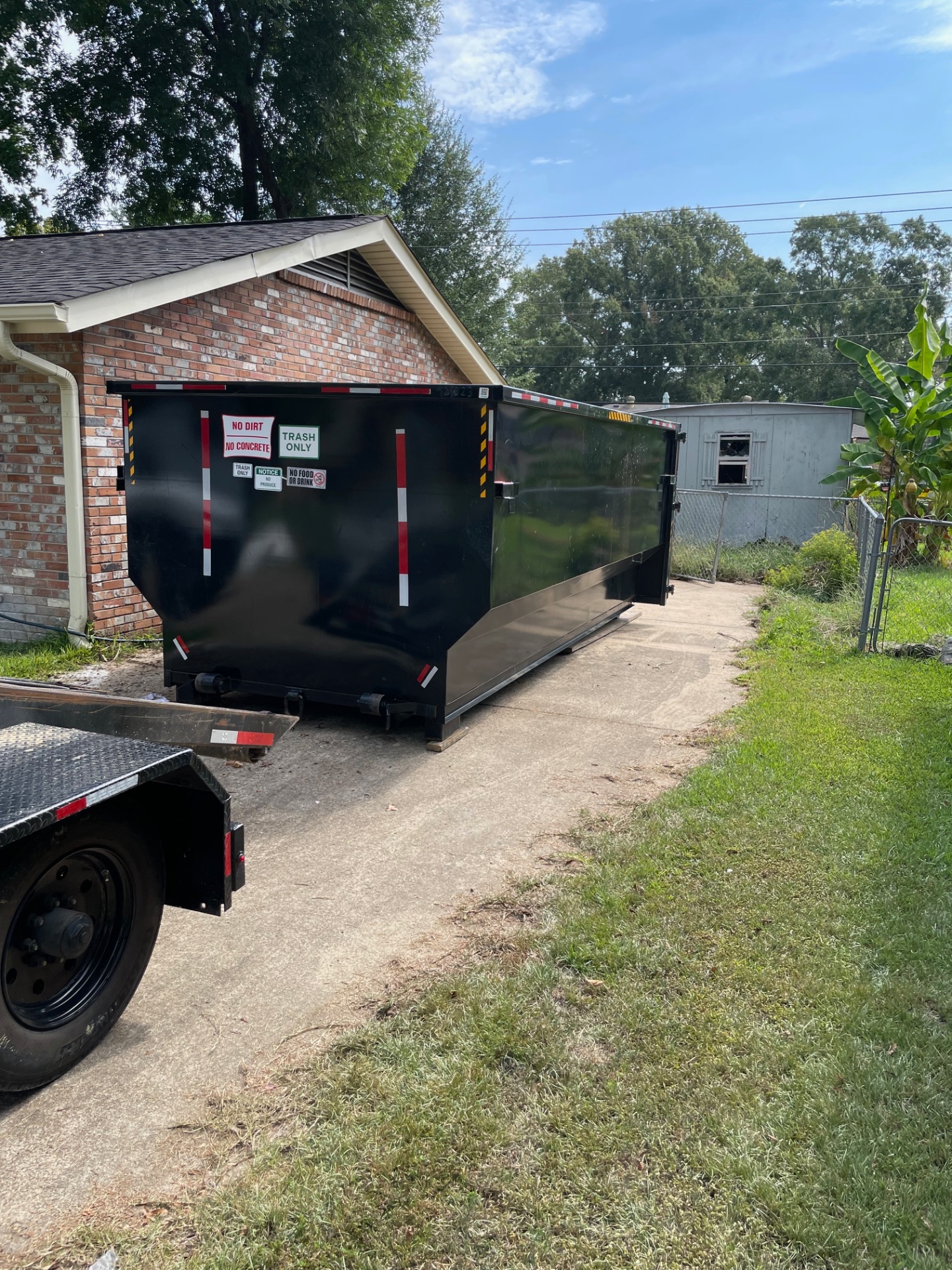 25 yard dumpster being set down from the truck