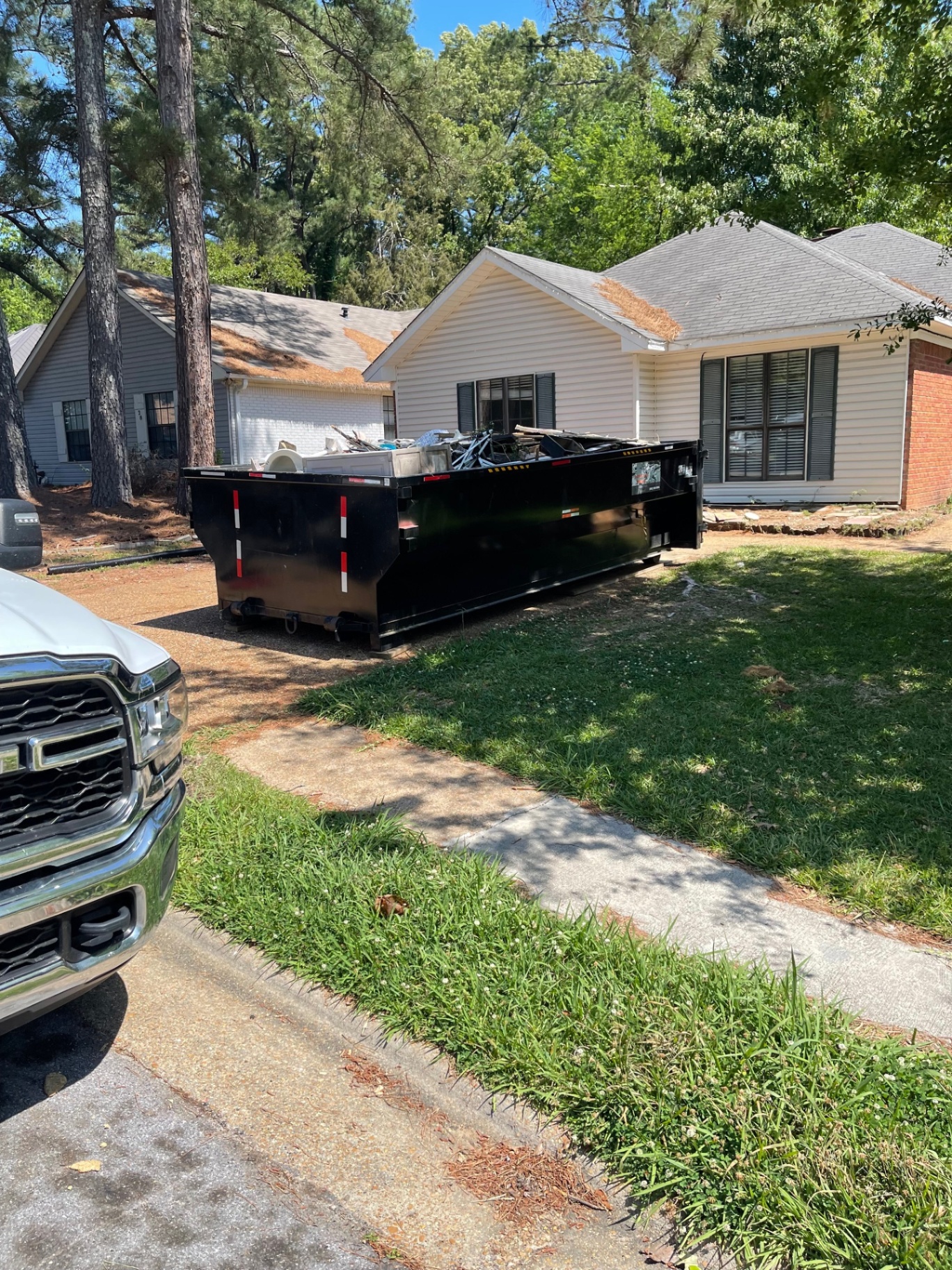 15 yard dumpster placed in a grassy yard