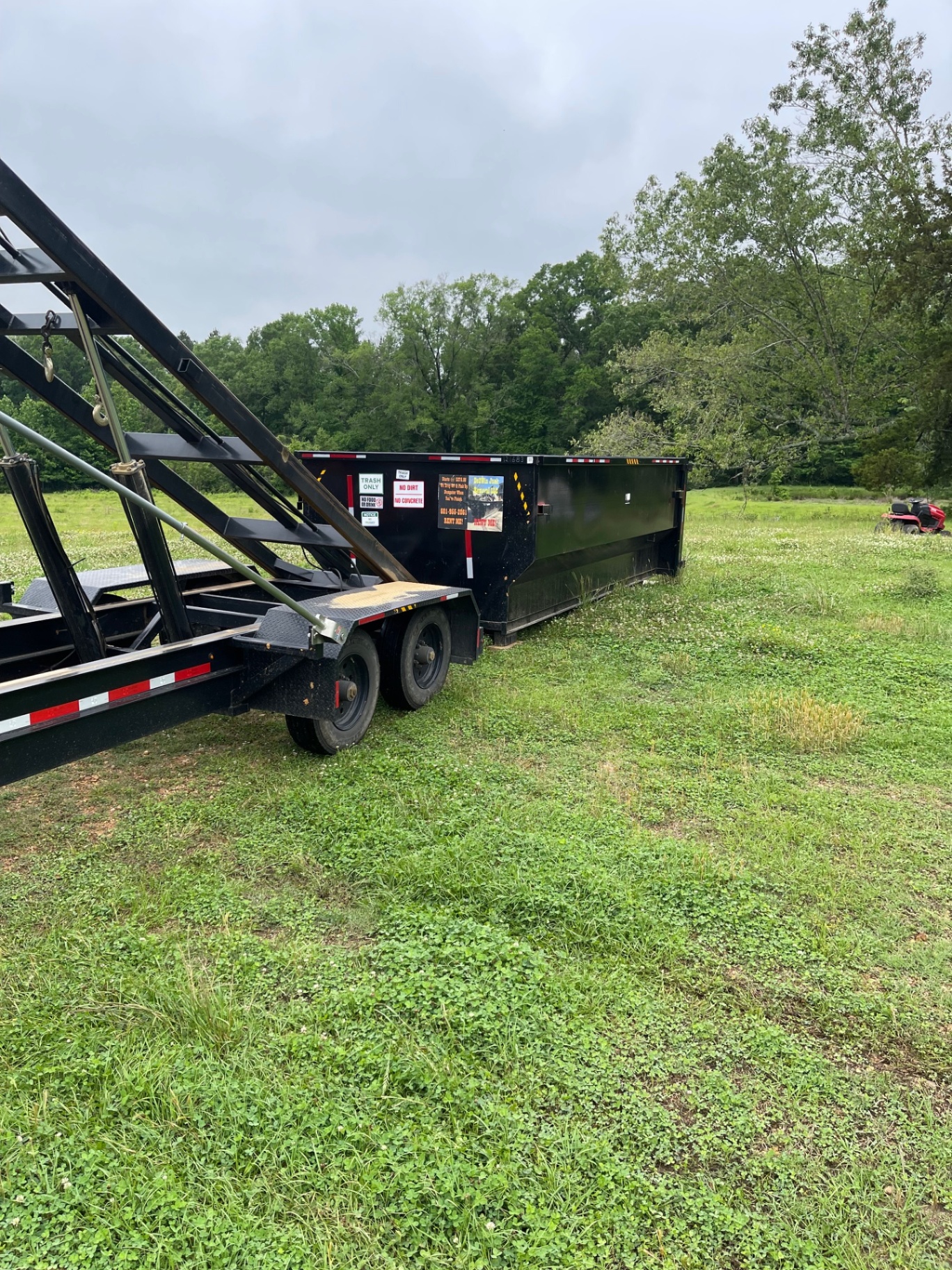 20 yard dumpster loaded at a rural residential property
