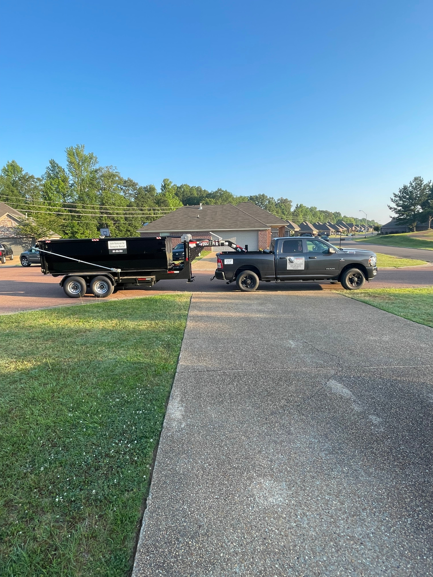 Do2Win Ram truck and dump trailer parked at a Mississippi home