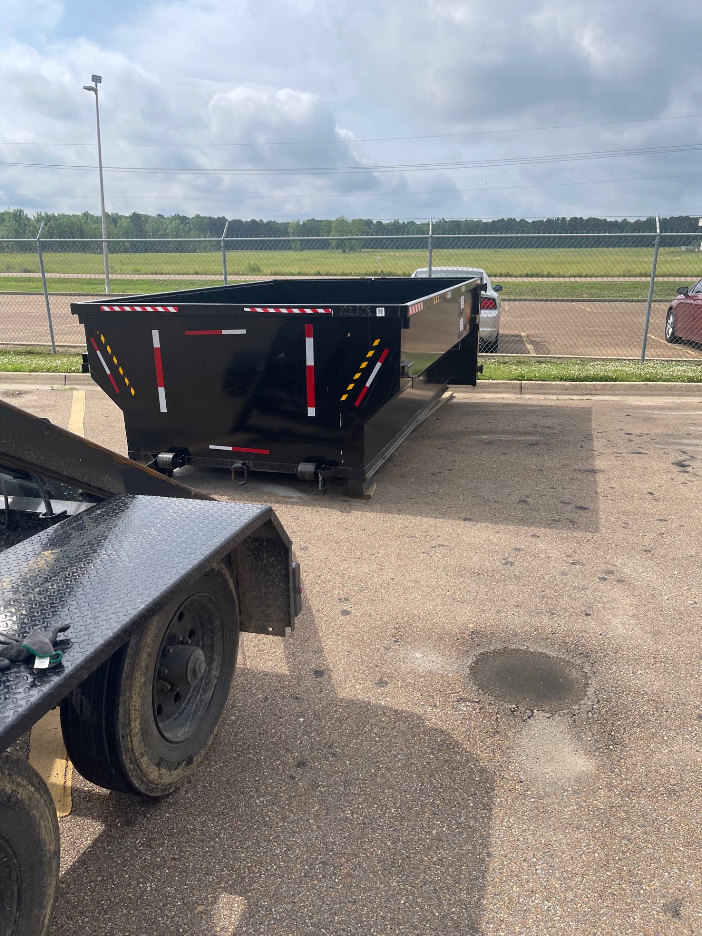 10 yard dumpster staged for delivery in a paved lot