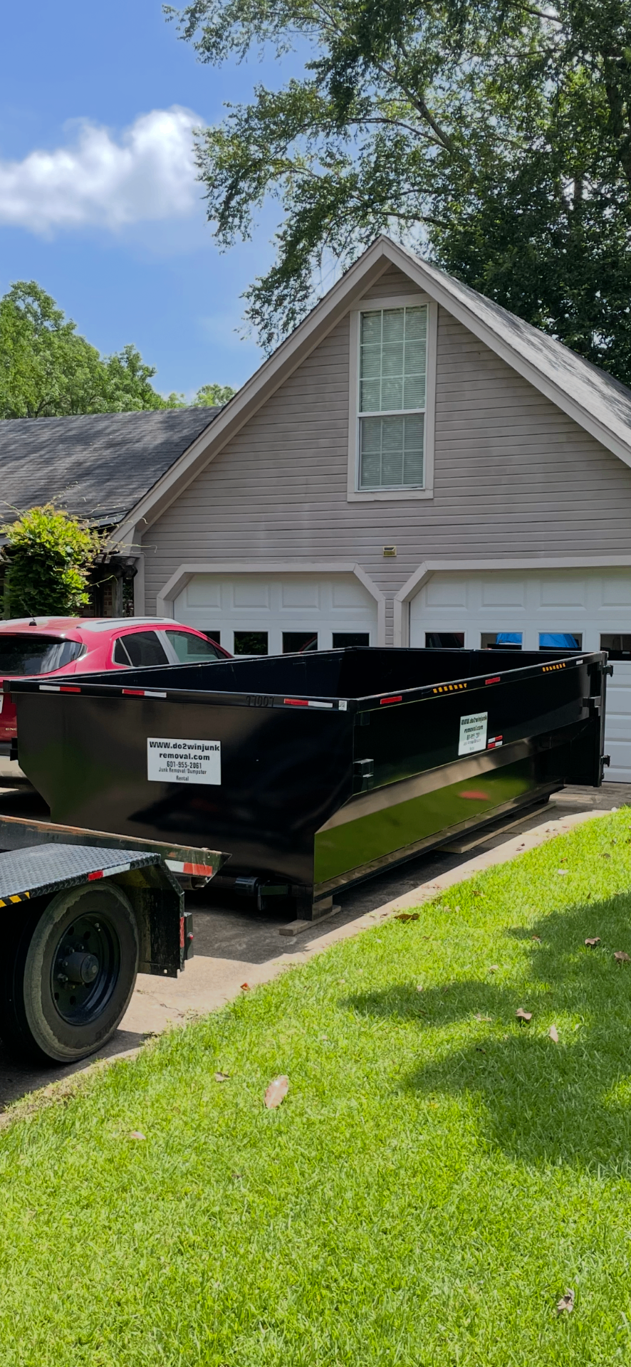 Dumpster delivered in front of a Mississippi home