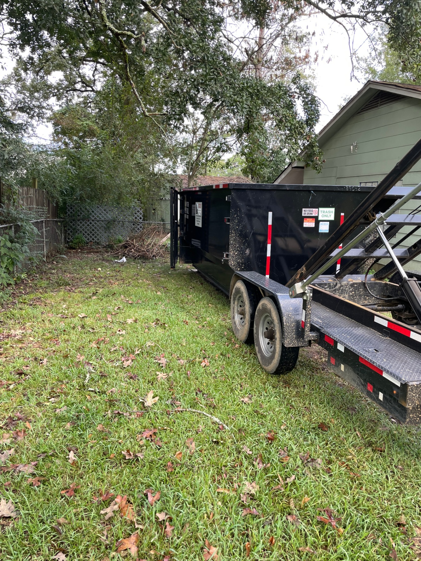 Dumpster on trailer with yard debris